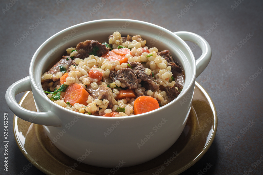 Homemade beef and barley soup. Gray background Homemade beef and barley soup. Gray background