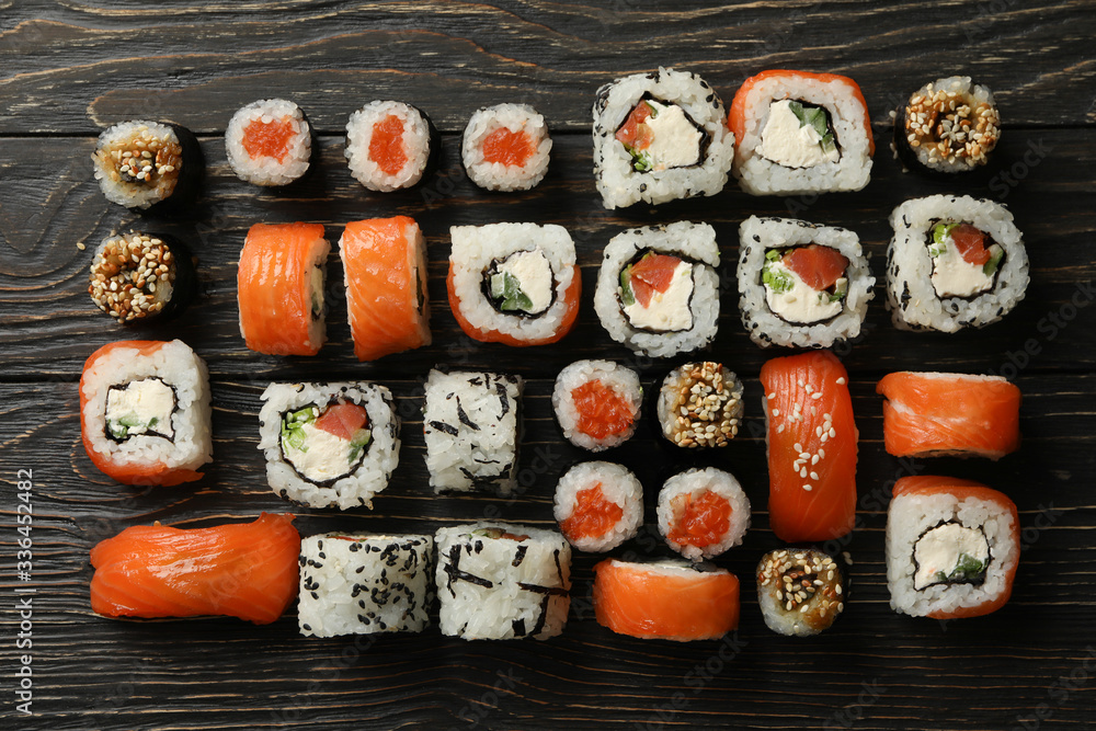 Flat lay with sushi rolls on wooden background. Japanese food Flat lay with sushi rolls on wooden background. Japanese food