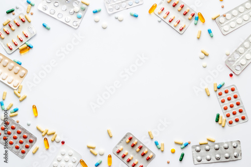 Flu treatment concept with medicine pills on white background top view copy space