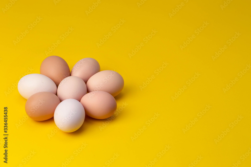 homemade eggs are laid out in the shape of a flower on a yellow background homemade eggs are laid out in the shape of a flower on a yellow background