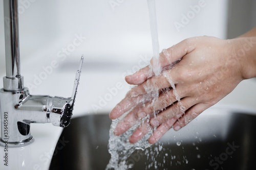 washing hands in sink