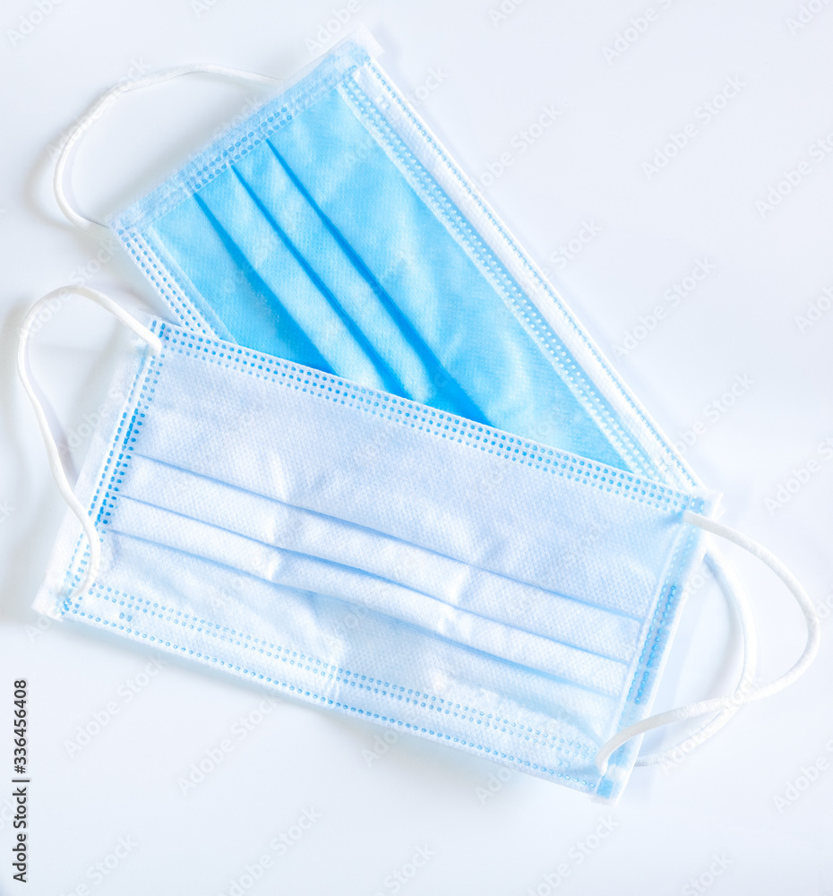 surgical face mask with rubber ear straps for protection against germs on white background surgical face mask with rubber ear straps for protection against germs on white background