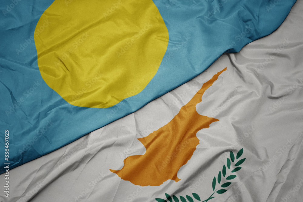 waving colorful flag of cyprus and national flag of Palau .