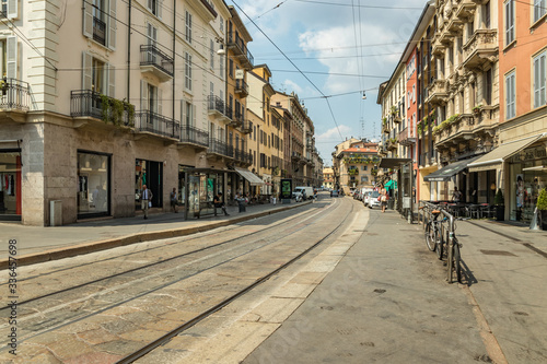 MILAN  ITALY - AUGUST 01  2019  Tourists and locals walk in the center of Milano. Shops  boutiques  cafes and restaurants