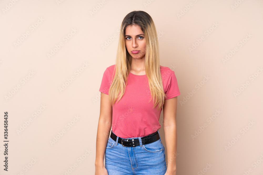 Young Uruguayan woman over isolated background with sad and depressed expression Young Uruguayan woman over isolated background with sad and depressed expression