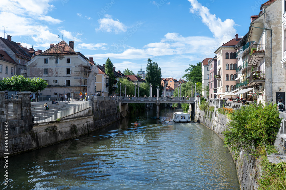 Obraz premium Ljubljana River in the largest city of Slovenia and a lot of historical building in the city center. June 2019