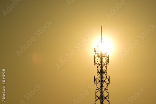 Wireless telephone pole and orange-yellow sky In the early morning of the day 