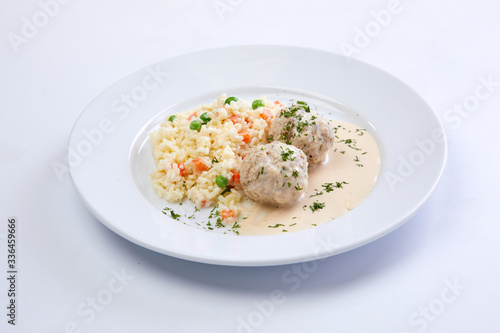 meatballs with rice and vegetables on the white background
