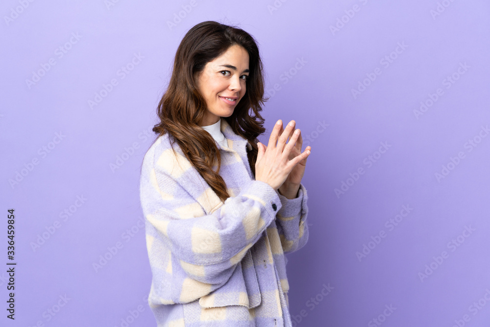 Woman over isolated purple background scheming something Woman over isolated purple background scheming something