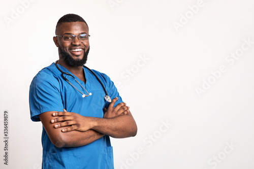 Successful black practitioner with glasses posing over white background