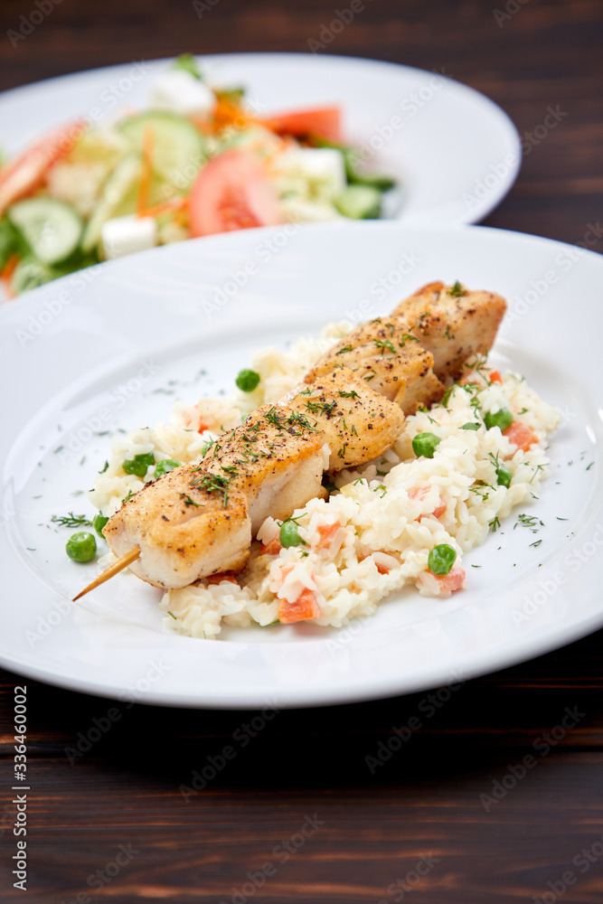 chicken kebab with rice and vegetables on the wooden background chicken kebab with rice and vegetables on the wooden background