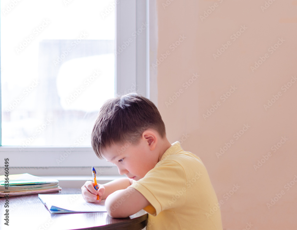 Asian child boy student in medical face mask homework online lesson at home, epidemic Coronavirus, MERS-CoV, 2019-nCoV, quarantine, Covid-19 self-isolation, online education, home schooling Asian child boy student in medical face mask homework online lesson at home, epidemic Coronavirus, MERS-CoV, 2019-nCoV, quarantine, Covid-19 self-isolation, online education, home schooling