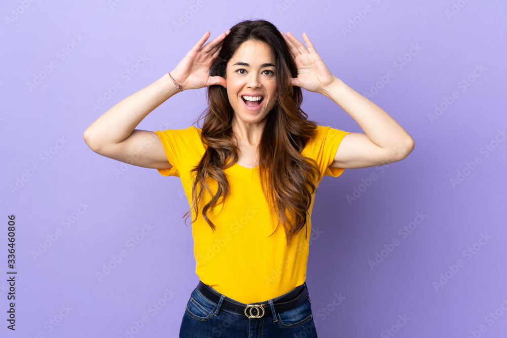 Woman over isolated purple background with surprise expression Woman over isolated purple background with surprise expression
