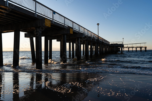 Wallpaper Mural Sunrise over Atlantic Ocean, blue sky, piers. Pier and blue Atlantic Ocean. Red sky sun beams.  Torontodigital.ca