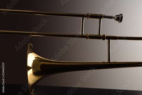 Backlit trombone with dark gradient background photo