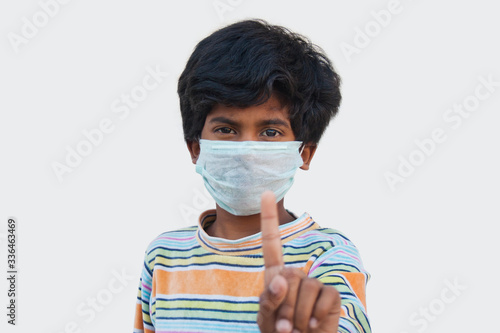 Portrait Of Boy Wearing Mask Pointing
 photo