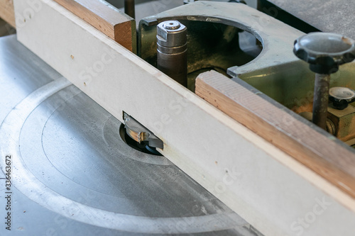 Close up shot of a carpentry machine in action. Woodworking concept, sawmill interior, lumber export service. 