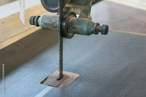 Close up shot of a rusty old saw, carpentry woodworking woodshop, machines and tools, wooden boards, furniture details. Wood plank jointing process on factory production line. Professional service.
 photo