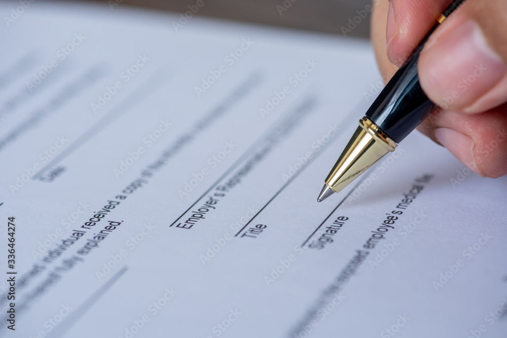 hand using a pen sign a signature hand using a pen sign a signature