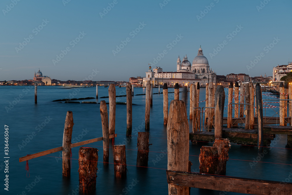 Venice, Italy - February 18, 2020 : A view of the Roman Catholic Santa Maria Della Salute Church and on the left side few people for the carnival
