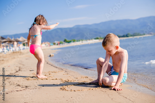 Boy and girl are playing in sand