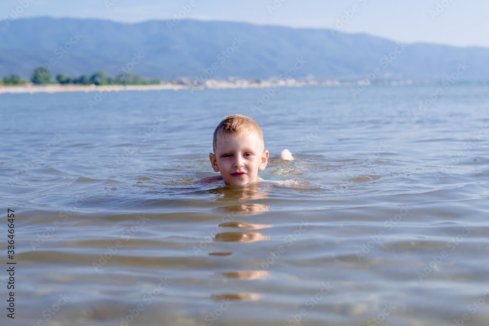Boy is swimming in sea