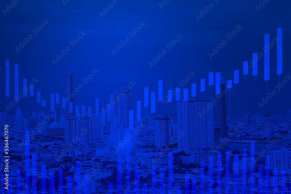 double exposure cityscape view and candlestick graph on blue background color concept