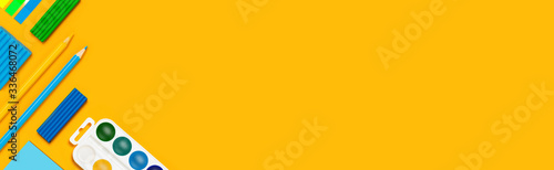 School supplies on yellow background. Back to school web banner. photo