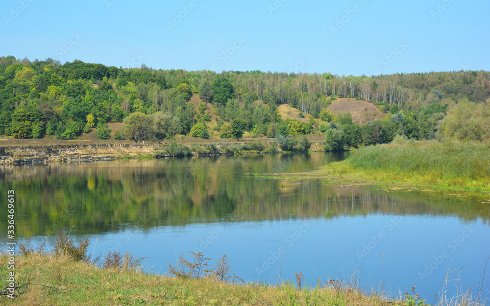 Picturesque landscape scenery of the Desna river with Mezyn National Nature Park in the background in summer.