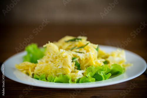 fried omelet with thin vermicelli with salad leaves in a plate