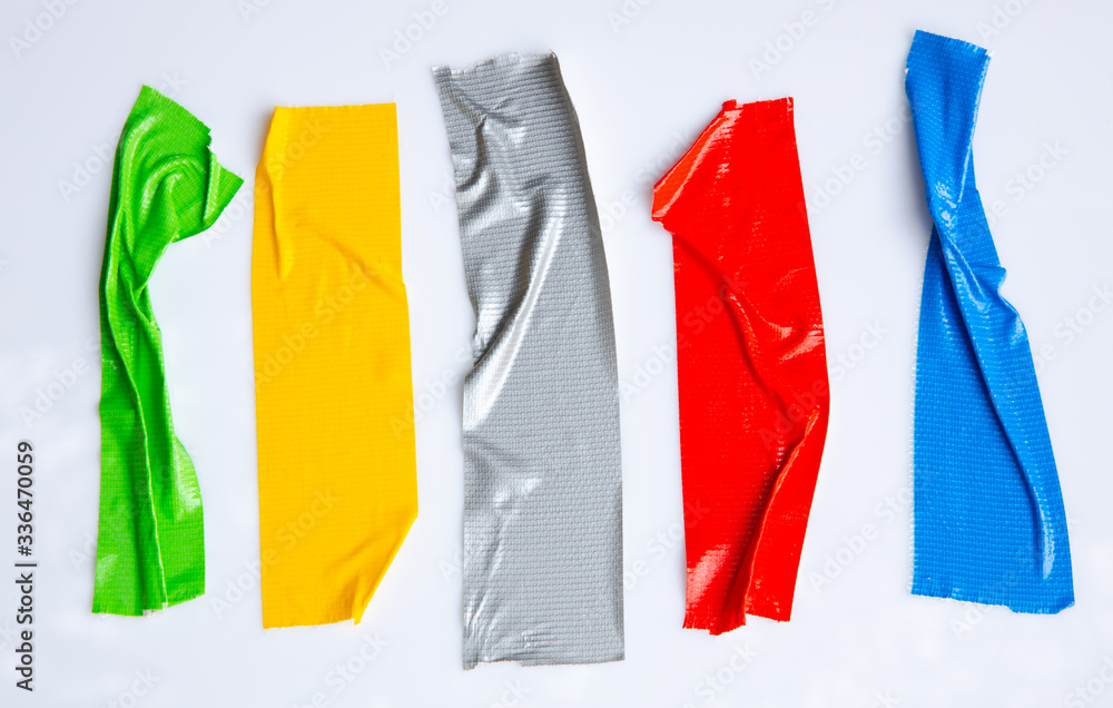 Set of red, gray, blue, yellow, green tapes on white background. Torn horizontal and different size sticky tape, adhesive pieces.