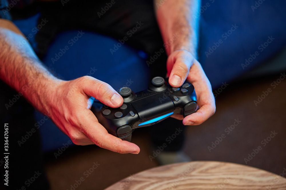 Gamer holding Gamepad, Controller or Videogame Joystick Console in hands. Close up, game concept Gamer holding Gamepad, Controller or Videogame Joystick Console in hands. Close up, game concept