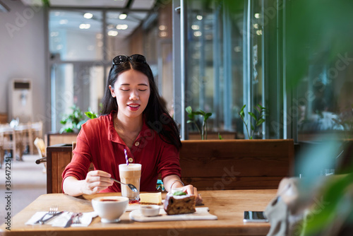 Girl having a cup of coffee and cake