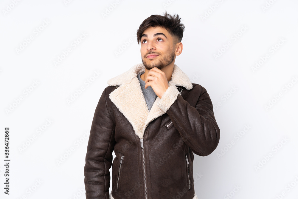 Arabian handsome man over isolated background and looking up Arabian handsome man over isolated background and looking up