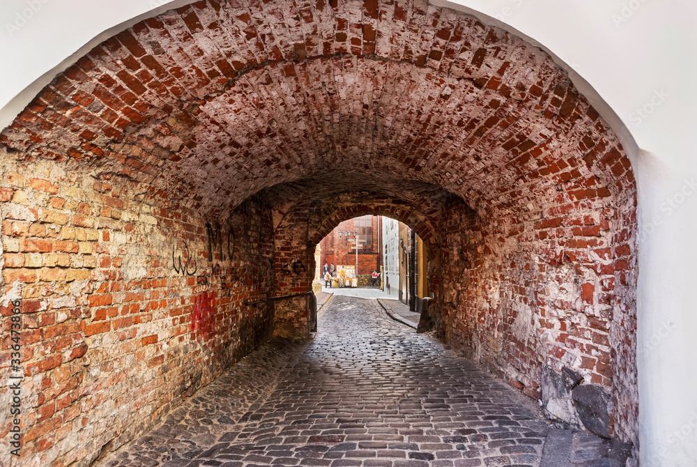 Archway in courtyard in historical center in Riga Baltic