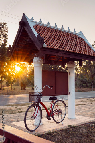 Vertical sunrise in Sukhothai park with a bike to sightseeing. Holidays and Travel concept. Traveling to Thailand to discover the mother nature lifestyle. South east culture and nature.