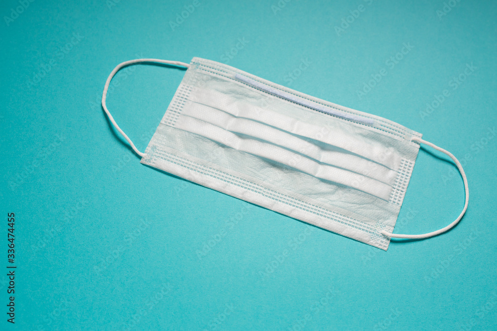 white medical antivirus mask on a blue background white medical antivirus mask on a blue background