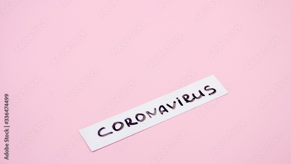 Fototapeta premium Nameplate coronavirus plate on a pink background