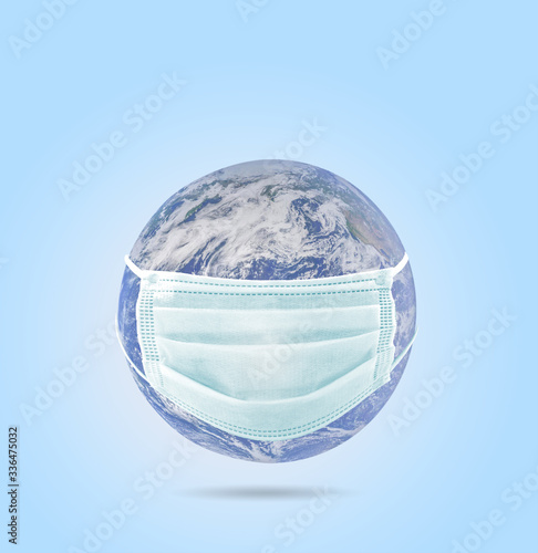 On planet earth  a medical mask to protect against the coronavirus epidemic. Concept of a global virus epidemic  concept of Corona virus quarantine  Covid-19. Elements of this image furnished by NAZA