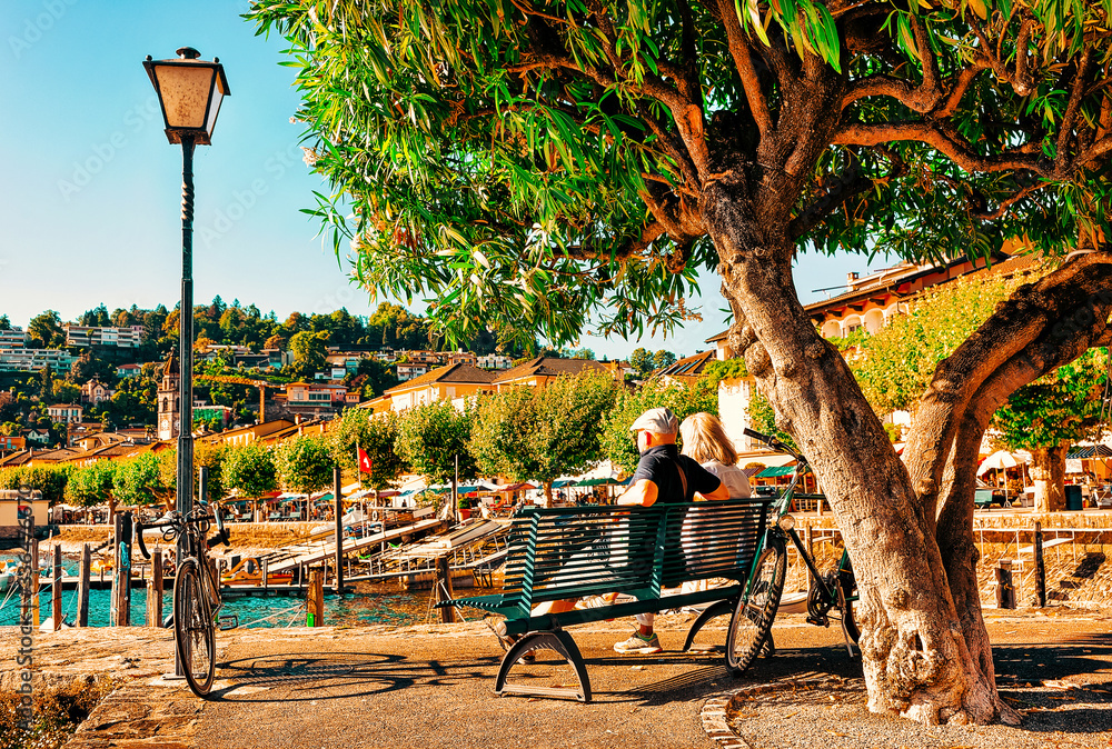 Senior couple sitting on bench of Ascona luxury tourist resort