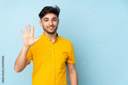 Arabian handsome man over isolated background counting five with fingers