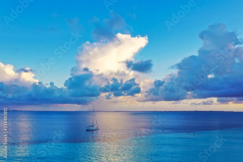 Boat on calm ocean and sunset