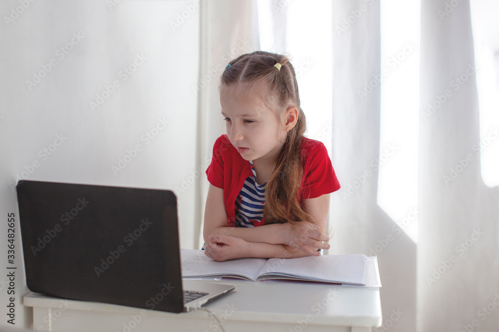 7 year old girl studying online. Webinar. Education at home. 7 year old girl studying online. Webinar. Education at home.
