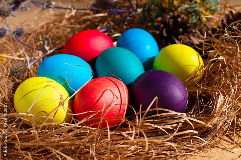 Painted Easter eggs in a nest of straw. Sunlight. Easter still life. Painted Easter eggs in a nest of straw. Sunlight. Easter still life.