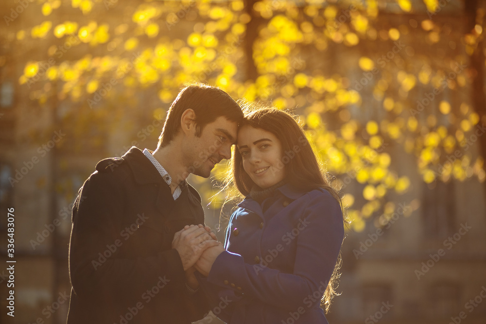 a guy with a girl walking in the park. Autumn in the park. sunny day a guy with a girl walking in the park. Autumn in the park. sunny day