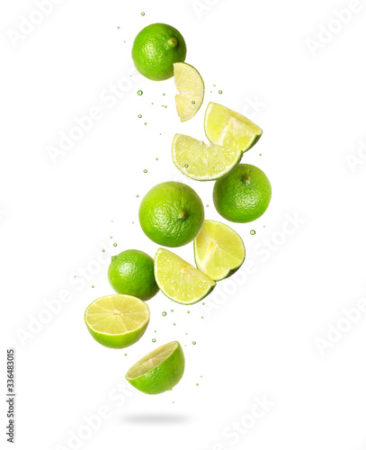 Whole and sliced fresh lime in the air on a white background © Krafla
