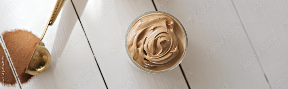 Iced frothy Dalgona Coffee, a trendy fluffy creamy whipped coffee. Korean drink latte espresso with coffee foam. made of instant coffee, sugar, hot water and milk. banner with copyspace. Iced frothy Dalgona Coffee, a trendy fluffy creamy whipped coffee. Korean drink latte espresso with coffee foam. made of instant coffee, sugar, hot water and milk. banner with copyspace.