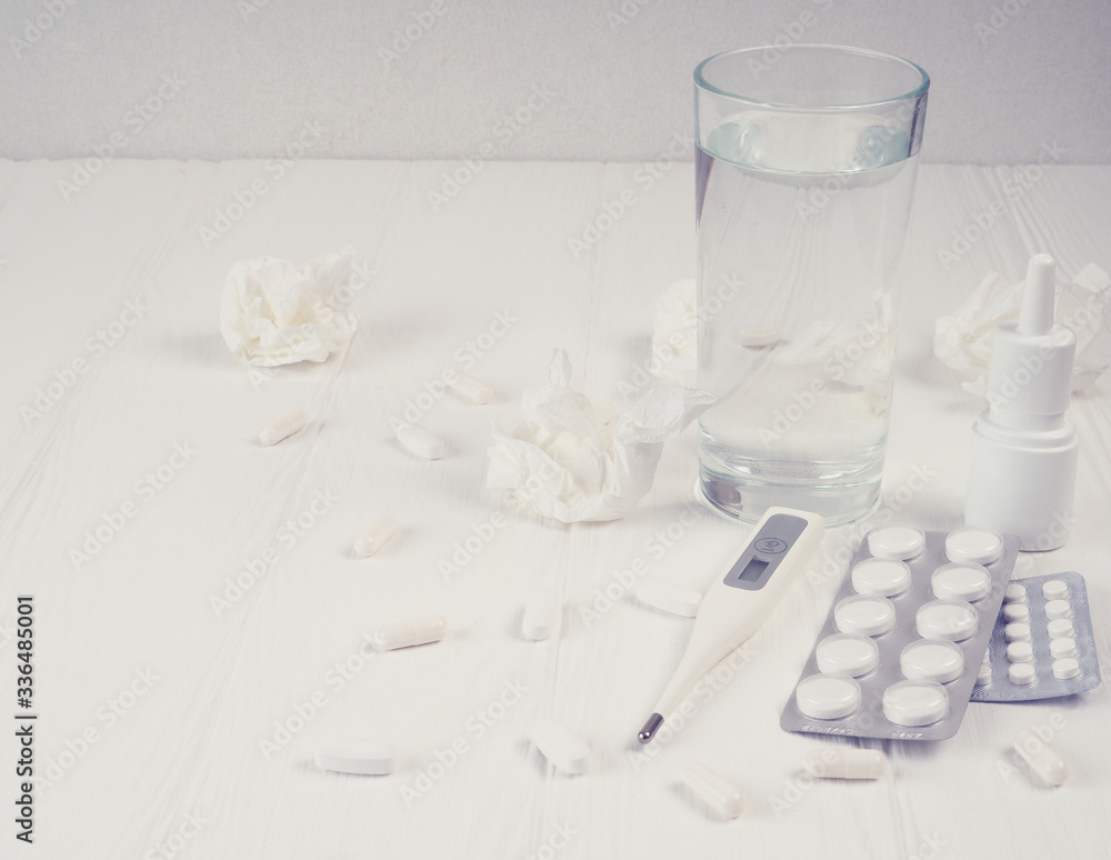 Pills in plastic package. Concept of healthcare and medicine. Coronavirus 2019-nCoV, thermometer, runny nose, treatment of the disease Pills in plastic package. Concept of healthcare and medicine. Coronavirus 2019-nCoV, thermometer, runny nose, treatment of the disease