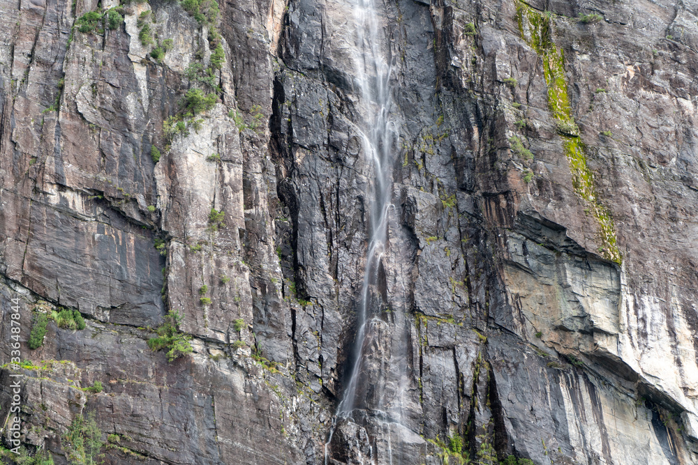 Fjord cruise: Small waterfall from the mountain in Bergen, Norway