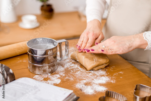 Woman's hands roll the dough. Protection Symbol, heat comfort.